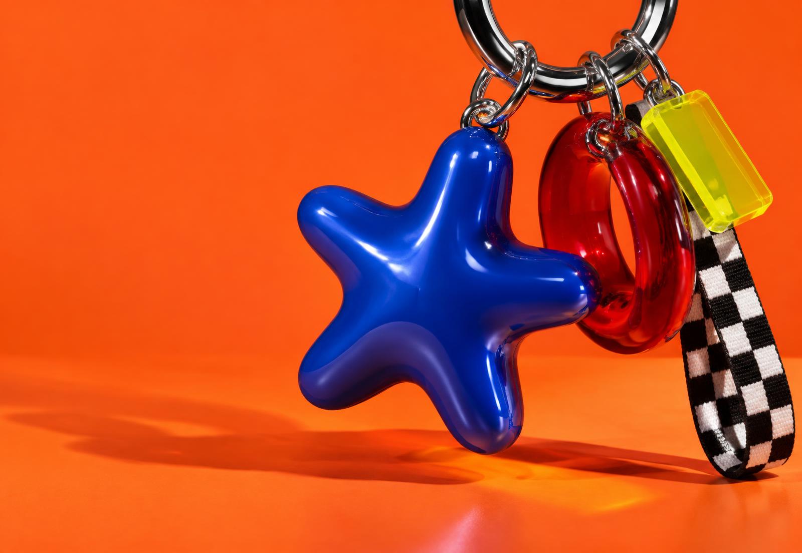 An experimental art direction study featuring colorful charms against vivid orange